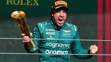 Aston Martin driver Fernando Alonso of Spain celebrates his third-place finish, on the podium at the end of the Brazilian Formula One Grand Prix at the Interlagos race track in Sao Paulo, Brazil, Sunday, Nov. 5, 2023. (AP Photo/Andre Penner)