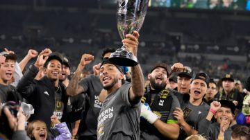 Los Angeles FC forward Denis Bouanga lifts the trophy after Los Angeles FC defeated Houston Dynamo 2-0 to win the MLS playoff Western Conference final soccer match Saturday, Dec. 2, 2023, in Los Angeles. (AP Photo/Marcio Jose Sanchez)