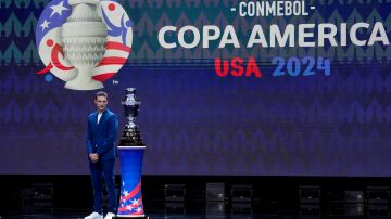 Argentina's soccer coach Lionel Scaloni watches the Copa America trophy during the draw ceremony for the Copa America soccer tournament, Thursday, Dec. 7, 2023, in Miami. The 16-nation tournament will be played in 14 U.S. cities starting with Argentina's opener in Atlanta on June 20, 2024. (AP Photo/Lynne Sladky)