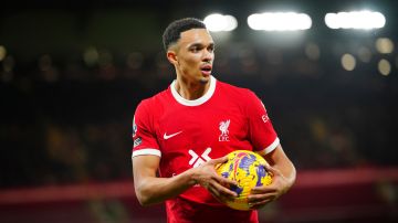 Liverpool's Trent Alexander-Arnold carries the ball during the English Premier League soccer match between Liverpool and Manchester United at the Anfield stadium in Liverpool, England, Sunday, Dec.17, 2023. (AP Photo/Jon Super)