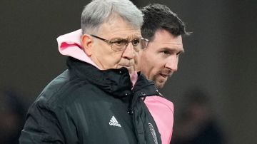 Inter Miami's head coach Gerardo "Tata" Martino, left, stands with forward Lionel Messi during the friendly soccer match between Vissel Kobe and Inter Miami CF at the National Stadium, Wednesday, Feb. 7, 2024, in Tokyo, Japan. (AP Photo/Eugene Hoshiko)