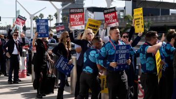 Flight attendants walk picket line at Los Angeles International Airport on Tuesday, Feb. 13, 2024. Flight attendants for major U.S. airlines are holding rallies at airports around the country to push for higher pay. (AP Photo/Richard Vogel)
