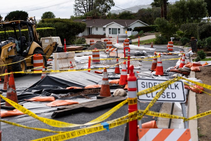 Caution tape closes off streets due to land movement intensified by recent storms in Rancho Palos Verdes, Calif., Tuesday, Feb. 20, 2024. Much of saturated California remains under threat of floods as the latest winter storm blows through, but so far the state has escaped the severity of damage spawned by a recent atmospheric river. (AP Photo/Jae C. Hong)