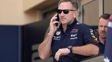 Red Bull team principal Christian Horner speaks on a mobile phone prior to the first practice session ahead of the Formula One Bahrain Grand Prix at the Bahrain International Circuit in Sakhir, Bahrain, Thursday, Feb. 29, 2024. (AP Photo/Darko Bandic)