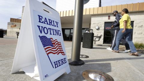 FILE - In this Oct. 24, 2012 file photo Oliver Solomon and his wife LaDonna arrive at the Davenport, Iowa, Public Library to cast their ballot early. For years, Democrats have dominated early voting in Iowa while Republicans largely focused on Election Day turnout. The GOP has invested millions in the Nov. 4, 2014 election and this time hopes to get conservatives to cast ballots early, a decision that may prove vital in a tight U.S. Senate race in Iowa. (AP Photo/Charlie Neibergall, File)