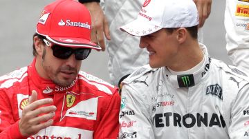 Mercedes Grand Prix driver Michael Schumacher of Germany, right, and Ferrari driver Fernando Alonso of Spain talk during the pilots official photo prior to the Formula One Brazilian Grand Prix at the Interlagos race track in Sao Paulo, Brazil, Sunday, Nov. 25, 2012. (AP Photo/Victor R. Caivano)
