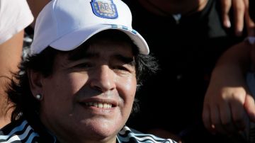 Argentina's soccer team coach Diego Maradona smiles as he poses for pictures during a training session in Buenos Aires, Tuesday, Feb. 9, 2010. Argentina will face Jamaica in a friendly soccer match on Wednesday. (AP Photo/Natacha Pisarenko)