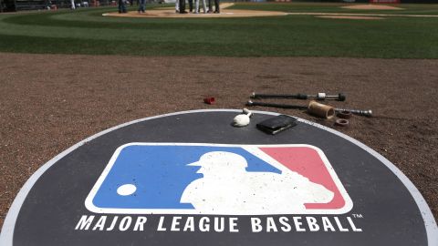 The Major League Baseball logo serves as the visitor's on deck circle before a baseball game between the Chicago White Sox and the Cleveland Indians Wednesday, April 24, 2013, in Chicago. (AP Photo/Charles Rex Arbogast)