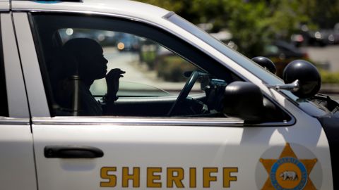 In this Tuesday, July 19, 2016 photo, Los Angeles County sheriff's deputy recruit Renata Phillip sits in a sheriff's vehicle during her training at the Biscailuz Regional Training Center in Monterey Park, Calif. Last August, 11 years into her career as a teacher, Phillip made a drastic change. She decided to quit teaching and become a Los Angeles County sheriff's deputy. Her decision came amid growing concern over police tactics in the wake of a number of deaths at the hands of officers of unarmed black men across the country. (AP Photo/Jae C. Hong)