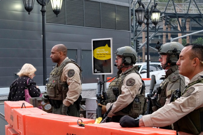 Los Angeles County Sheriff's deputies stand on guard at the Universal City Red Line station in Los Angeles on Tuesday, Dec. 6, 2016. Heavily armed sheriff's deputies are guarding the station and other parts of Los Angeles County's transit system following a threat of a terror attack against the busy commuter rail station. (AP Photo/Richard Vogel)