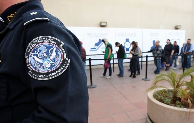 FILE - In this Dec. 10, 2015, file photo, pedestrians crossing from Mexico into the United States at the Otay Mesa Port of Entry wait in line in San Diego. U.S. Customs and Border Protection officers will be key players in putting President Donald Trump's revised travel ban into effect on Thursday, June 29, affecting visitors from six mostly Muslim countries. The busiest point of entry is San Diego's San Ysidro crossing with Tijuana, Mexico, with 31.8 million admissions during the latest 12-month period, an average of 87,000 a day. (AP Photo/Denis Poroy, File)