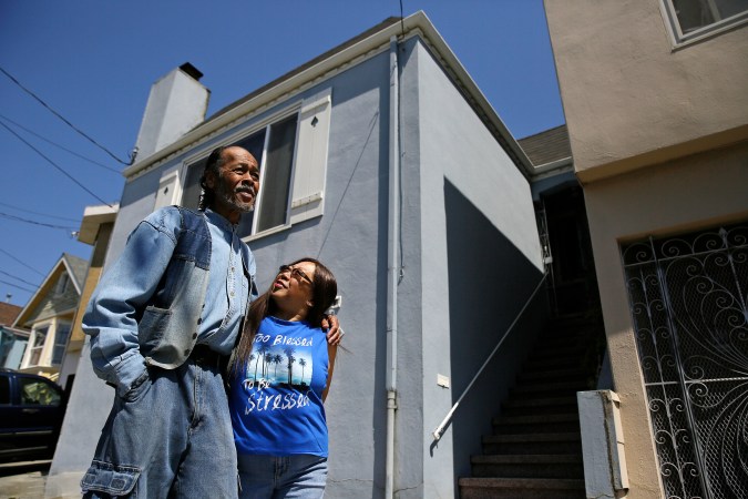 In this photo taken Thursday, June 22, 2017, Graciano and Buena de la Cruz stand outside their home in San Francisco. Graciano, 70, grew up in San Francisco, the child of a Filipino father and an African-American mother. He and his wife, Buena, who is Filipino-American, must now sell their own home of two decades to pay off a debt that stemmed from a "pick-a-payment" loan with World Savings Bank in August 2006. (AP Photo/Eric Risberg)