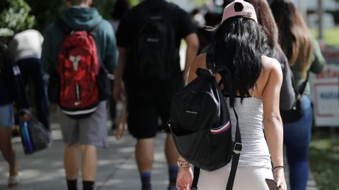 FILE- In this Oct. 23, 2018, file photo, students walk on the campus of Miami Dade College, in Miami. The nine companies and organizations tasked with servicing the accounts of the nation’s 30 million student loan borrowers repeatedly failed to do their jobs properly over a period of years and their regulator neglected to hold them responsible, a new report finds. The report released Thursday, Feb. 14, 2019, by the Department of Education’s independent Inspector General’s office shows some borrowers weren’t getting the guidance and protection they needed as they sought the best plan for paying off their student loans. (AP Photo/Lynne Sladky)