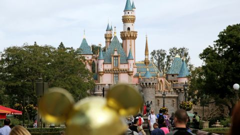 FILE - In this Jan. 22, 2015, file photo, visitors walk toward Sleeping Beauty's Castle in the background at Disneyland Resort in Anaheim, Calif. A teenage girl traveling from New Zealand to Southern California this month was infectious with highly contagious measles and may have exposed others at Disneyland and a nearby hotel, health officials said Friday, Aug. 23, 2019. (AP Photo/Jae C. Hong, File)