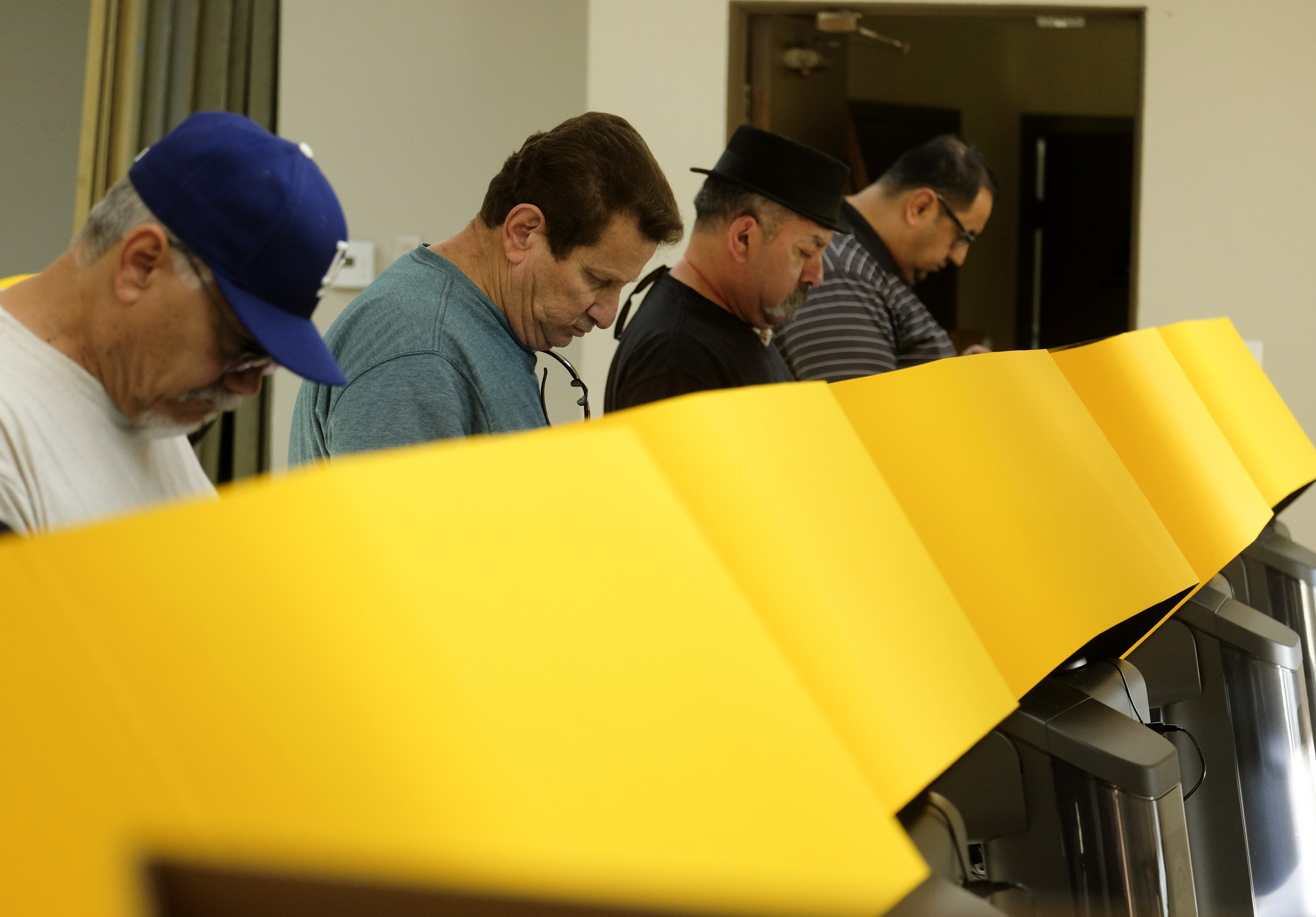 FILE - In this Tuesday, March 3, 2020 file photo, voters cast their ballots in the California Primary Super Tuesday at a voting center in Rosemead, Calif. California's top election official says Los Angeles County should mail ballots to its 5.5 million registered voters at least 29 days ahead of the November general election to avoid the lengthy delays that plagued polling places in the nation's most populous county on Super Tuesday. (AP Photo/Ringo H.W. Chiu, File)