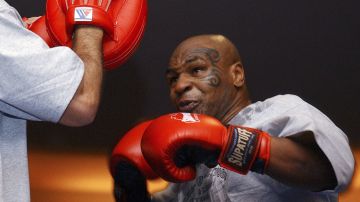 FILE - In this Aug. 30, 2006, file photo, former heavyweight boxing champion Mike Tyson spars during a training exhibition in Las Vegas. Tyson hasn’t announced any plans to return to the ring, though he did suggest on an Instagram post he might make himself available for 3 or 4-round exhibitions if the price was right. And already some people in Australia are talking about offering him $1 million to fight an exhibition against a rugby star or two. (AP Photo/Marlene Karas, File)