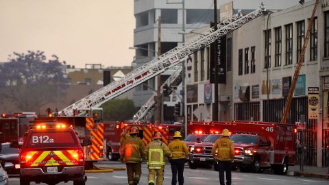 Los Angeles Fire Department firefighters work the scene of a structure fire that injured multiple firefighters, according to a fire department spokesman, Saturday, May 16, 2020, in Los Angeles. (AP Photo/Mark J. Terrill)