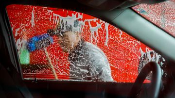 Vivas Hand Car Wash owner Telesforo Vivas, of Sanford N.C., who has been in business for 5 years, washes a car window, in Burlington, N.C., Wednesday, March 11, 2020. His car wash is along a businesses strip of Latino-owned businesses. (AP Photo/Jacquelyn Martin)