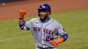 New York Mets' Robinson Cano (24) reacts after scoring during a baseball game against the Miami Marlins, Monday, Aug. 17, 2020, in Miami. (AP Photo/Lynne Sladky)
