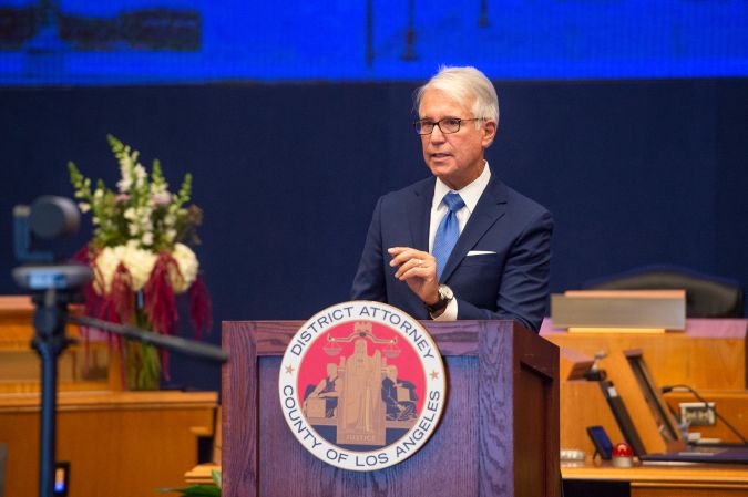 In this photo provided by the County of Los Angeles, incoming Los Angeles County District Attorney George Gascon speaks after he was sworn in during a mostly-virtual ceremony in downtown Los Angeles Monday, Dec. 7, 2020. Gascon, who co-authored a 2014 ballot measure to reduce some nonviolent felonies to misdemeanors, has promised more reforms to keep low-level offenders, drug users and those who are mentally ill out of jail and has said he won't seek the death penalty. (Bryan Chan/County of Los Angeles via AP)