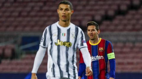 FILE - In this Tuesday, Dec. 8, 2020 file photo Barcelona's Lionel Messi, right, and Juventus' Cristiano Ronaldo during the Champions League group G soccer match between FC Barcelona and Juventus at the Camp Nou stadium in Barcelona, Spain. UEFA says players at Super League clubs will be banned from national teams, including for Euro 2020 and World Cup. (AP Photo/Joan Monfort, File)