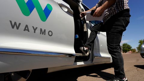 A Waymo minivan arrives to pick up passengers for an autonomous vehicle ride, Wednesday, April 7, 2021, in Mesa, Ariz. Waymo, a unit of Google parent Alphabet Inc., is one of several companies testing driverless vehicles in the U.S. But it's the first offering lifts to the public with no humans at the wheel who can take over in sticky situations. (AP Photo/Ross D. Franklin)