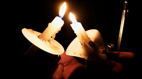 A candlelight vigil to honor victims of the Tulsa race massacre is held Monday, May 31, 2021, in Tulsa, Okla., at 10:30 p.m., local time, to coincide with the timing of the first shots fired on this date in 1921. (AP Photo/Sue Ogrocki)