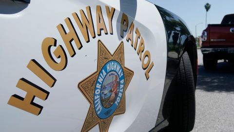 FILE - In this April 23, 2020, file photo, a California Highway Patrol officer stops a motorist in Anaheim, Calif. California Attorney General Rob Bonta announced, Thursday, July 8, 2021, that six officers working out of East Los Angeles, have been criminally charged for exaggerating their overtime hours while providing protection for state highway workers during road construction projects. (AP Photo/Chris Carlson, File)