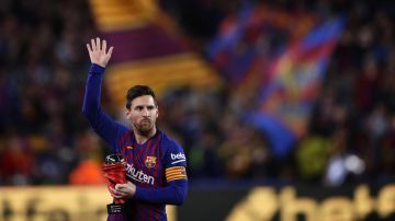 FILE - In this Saturday, April 6, 2019 file photo, Barcelona forward Lionel Messi waves at the crowd as he holds the trophy of the best Spanish La Liga player prior to a soccer match between FC Barcelona and Atletico Madrid at the Camp Nou stadium in Barcelona, Spain. Barcelona says Lionel Messi will not stay with the club, it was reported on Aug. 5, 2021 in a statement that a deal between the club and the player had been reached but financial “obstacles” made it impossible for the player to remain with the club. (AP Photo/Manu Fernandez, File)