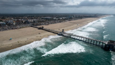 This aerial photo shows a reopened beach in Huntington Beach, Calif., Monday, Oct. 11, 2021. Huntington Beach reopened its shoreline this morning after water testing results came back with non-detectable amounts of oil associated toxins in ocean water, city officials and California State Parks announced. (AP Photo/Ringo H.W. Chiu)