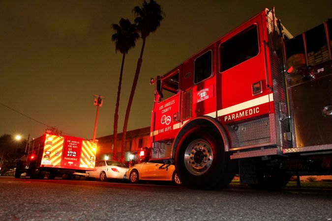 Los Angeles County Fire Department vehicles sit at a medical call Friday, Jan. 7, 2022, in Inglewood, Calif. Occasionally, firefighters transport patients to the hospital in fire engines because of short staffing amid an explosion in omicron-fueled coronavirus infections at an ambulance company that the fire department contracts with. (AP Photo/Mark J. Terrill)