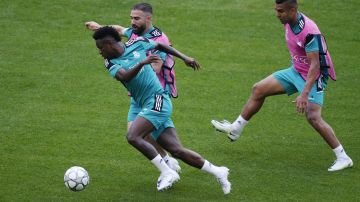 Real Madrid's Vinicius Junior, left, Dani Carvajal, center, and Casemiro attend a training session at the Stade de France in Saint Denis near Paris, Friday, May 27, 2022. Liverpool and Real Madrid are making their final preparations before facing each other in the Champions League final soccer match on Saturday. (AP Photo/Kirsty Wigglesworth)