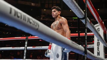 Ryan Garcia waits as Javier Fortuna knees on the canvas after being knocked down during a 12-round lightweight boxing match Saturday, July 16, 2022, in Los Angeles. (AP Photo/Ringo H.W. Chiu)