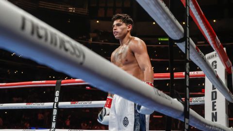 Ryan Garcia waits as Javier Fortuna knees on the canvas after being knocked down during a 12-round lightweight boxing match Saturday, July 16, 2022, in Los Angeles. (AP Photo/Ringo H.W. Chiu)