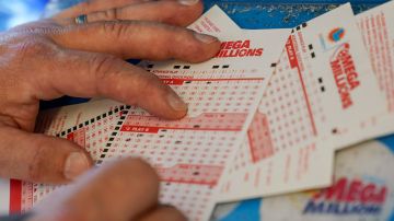 FILE - In this July 26, 2022 file photo, Gordon Midvale fills out a lottery ticket inside a 7-Eleven store in Oakland, Calif. The Mega Millions lottery jackpot has topped $1 billion — only the fourth time a lottery game has reached such heights. (AP Photo/Godofredo A. Vásquez, File)