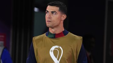 Portugal's Cristiano Ronaldo walks to his team bench at the beginning of the World Cup quarterfinal soccer match between Morocco and Portugal, at Al Thumama Stadium in Doha, Qatar, Saturday, Dec. 10, 2022. (AP Photo/Petr David Josek)