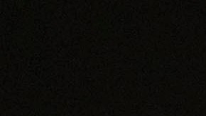 In this photo illuminated by an off-camera flash, a woman walks past a homeless person's tent with a chair in downtown Los Angeles, Thursday, Feb. 16, 2023. A new study by the University of California, San Francisco shows that homeless people in California were struggling with poor health and deep poverty before becoming homeless. The study released Tuesday, June 20, by the Benioff Homelessness and Housing Initiative aims to provide a comprehensive picture of adult homelessness in a state that has 30% of the country's homeless. (AP Photo/Jae C. Hong)