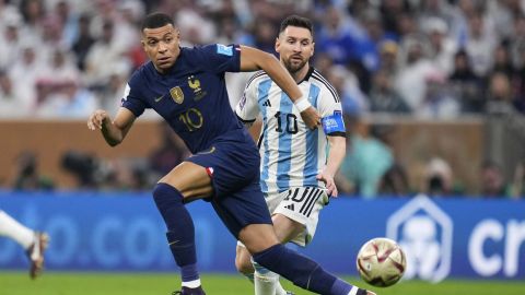 FILE - France's Kylian Mbappe and Argentina's Lionel Messi go for the ball during the World Cup final soccer match between Argentina and France at the Lusail Stadium in Lusail, Qatar, Sunday, Dec. 18, 2022. Mbappe has told Paris Saint-Germain he will leave the club at the end of the season, it was reported on Thursday, Feb. 15, 2024. (AP Photo/Manu Fernandez, File)