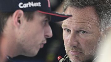 Red Bull team principal Christian Horner, right, talks to Red Bull driver Max Verstappen of the Netherlands before the qualifying session ahead of Sunday's Formula One Italian Grand Prix auto race, at the Monza racetrack, in Monza, Italy, Saturday, Sept. 2, 2023. (Christian Bruna/Pool via AP)