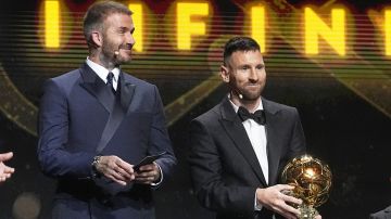 Inter Miami team co-owner and former soccer star David Beckham, left, smiles as Inter Miami's and Argentina's national team player Lionel Messi receives the 2023 Ballon d'Or trophy from during the 67th Ballon d'Or (Golden Ball) award ceremony at Theatre du Chatelet in Paris, France, Monday, Oct. 30, 2023. (AP Photo/Michel Euler)