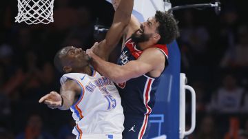 Oklahoma City Thunder center Bismack Biyombo (15) blocks a shot by Washington Wizards forward Anthony Gill, right during the second half of an NBA basketball game Friday, Feb. 23, 2024, in Oklahoma City. (AP Photo/Nate Billings)