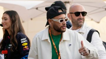 Brazilian soccer player Neymar, center, arrives in the VIP area prior to the Formula One Bahrain Grand Prix at the Bahrain International Circuit in Sakhir, Bahrain, Saturday, March 2, 2024. (AP Photo/Darko Bandic)