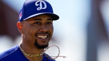 Los Angeles Dodgers second baseman Mookie Betts runs back to the dugout in the middle of the second inning of a spring training baseball game against the Colorado Rockies in Phoenix, Sunday, March 3, 2024. (AP Photo/Ashley Landis)