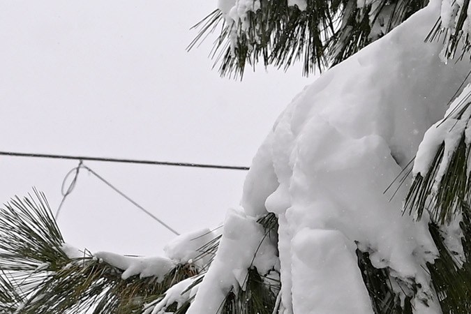 A stop sign is half buried in snow in a Donner Lake neighborhood on Friday, March 4, 2024, in Truckee, Calif. A powerful blizzard that closed highways and ski resorts had moved through the Sierra Nevada by early Monday, but forecasters warned that more snow was on the way for the Northern California mountains. More than 7 feet (2.1 meters) of snow fell in some locations and fierce winds lashed the Sierra over the weekend. (AP Photo/Andy Barron)