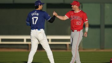 Los Angeles Dodgers designated hitter Shohei Ohtani (17) greets Los Angeles Angels center fielder Mike Trout (27) before a spring training baseball game in Phoenix, Tuesday, March 5, 2024. (AP Photo/Ashley Landis)
