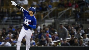 Los Angeles Dodgers designated hitter Shohei Ohtani reacts after flying out to center field during the fifth inning of a spring training baseball game against the Los Angeles Angels in Phoenix, Tuesday, March 5, 2024. (AP Photo/Ashley Landis)