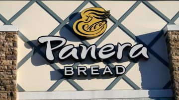 FILE - A Panera Bread logo is attached to the outside of a Panera Bread restaurant location, Tuesday, Dec. 20, 2022, in Westwood, Mass. Greg Flynn, a wealthy campaign donor of California Gov. Gavin Newsom, said the Panera Bread restaurants he owns will start paying workers at least $20 an hour on April 1 after controversy over whether a new state minimum wage law for fast food workers applies to his businesses. (AP Photo/Steven Senne,File)