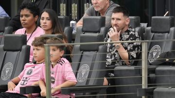 Inter Miami forward Lionel Messi, right, watches from his sideline box during the first half of an MLS soccer match against CF Montreal, Sunday, March 10, 2024, in Fort Lauderdale, Fla. (AP Photo/Rebecca Blackwell)