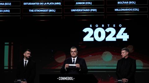 Competitions Director of Conmebol Frederico Nantes, center, holds a paper with the name of Argentina's Rosario Central during the Copa Libertadores draw in Luque, Paraguay, Monday, March 18, 2024. (AP Photo/Jorge Saenz)