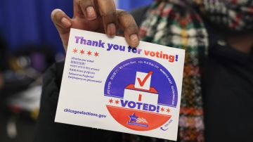 Una votante muestra su cartel después de emitir su voto en Chicago, Illinois, uno de los cinco estados que celebraron primarias presidenciales.